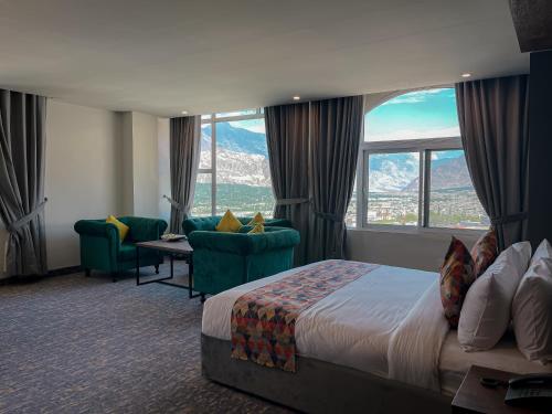 a hotel room with a bed and a view of mountains at Destination Hotel Gilgit in Gilgit