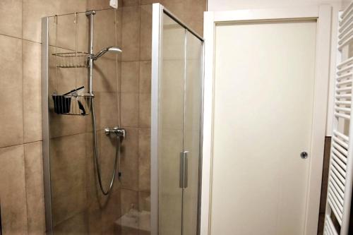 a bathroom with a shower with a glass door at Villetta Pima in Garda