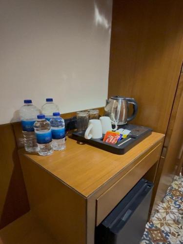 a table with bottles of water and a tray on it at Centre Point Amravati in Amrāvati