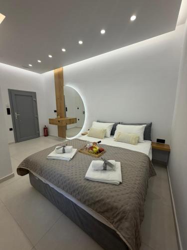 a bedroom with a large bed with two dishes on it at Naxian Roots in Galini