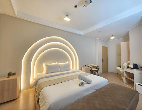 a bedroom with a large bed with an arch above it at Tamashii Boutique Hotel in Bandung