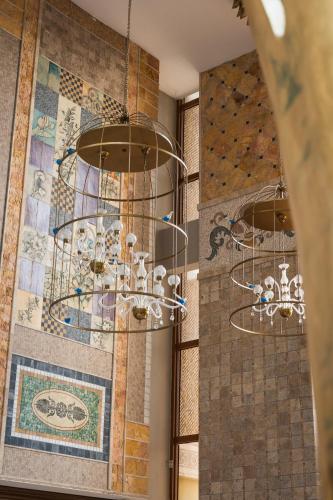 a chandelier in a room with a mosaic wall at Adalya Art Side - Ultra All Inclusive in Side
