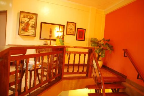 a hallway with a staircase with orange walls at Centro Mactan Suites in Mactan