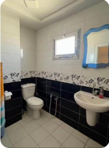 a bathroom with a toilet and a sink at Dar zgolli in Kelibia