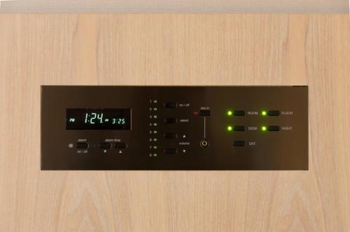 a close up of a remote control on a wooden wall at Rhino Hotel Kyoto in Kyoto