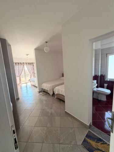 a bedroom with a bed and a room with a bathroom at Hotel Klaivi in Lezhë