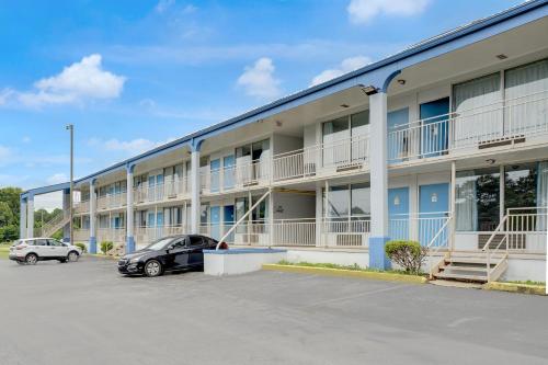 a large building with cars parked in a parking lot at Ole South Inn Jackson I 40 TN in Denmark