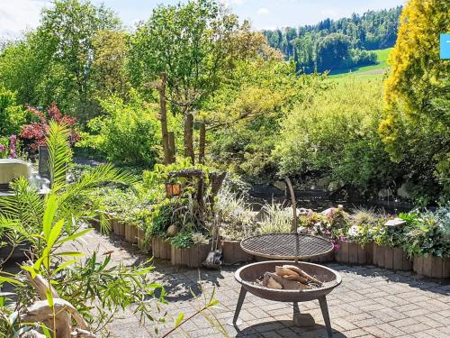 a garden with a table and a bunch of plants at Apartment Ferienhüsli by Interhome in Siglistorf