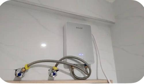 a white wall with a wire hooked up to a machine at The Loftel in Ruaka