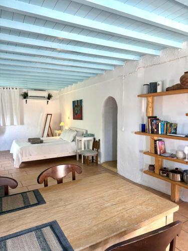 a large room with a bed and a table at Lilly's seaview Apartment in Mikonos