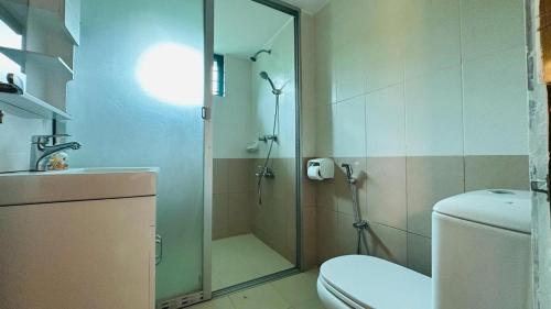a bathroom with a shower and a toilet and a sink at Neelima Resort in Cox's Bazar