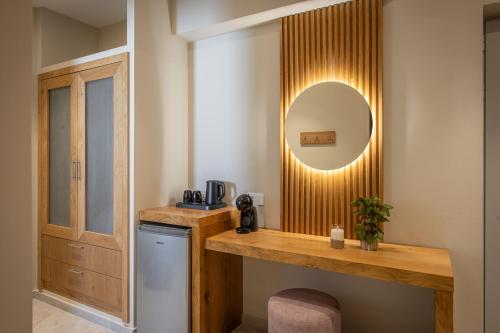 a bathroom with a counter and a mirror on the wall at South Coast Hotel in Makry Gialos
