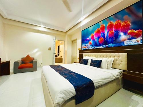 a bedroom with a large painting above a bed at Hotel Inani Long Bay in Cox's Bazar