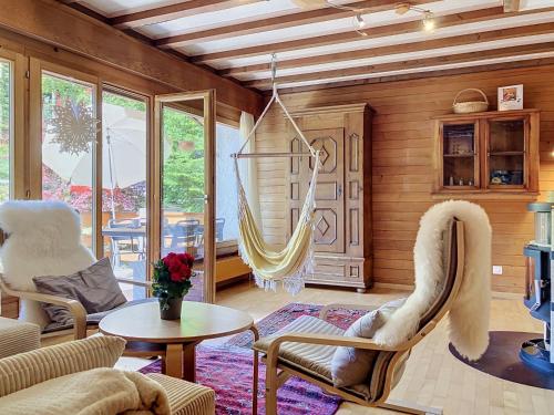 a living room with a hammock in a house at Chalet Chalet Chaudoudoux - Les Paccots by Interhome in Les Paccots