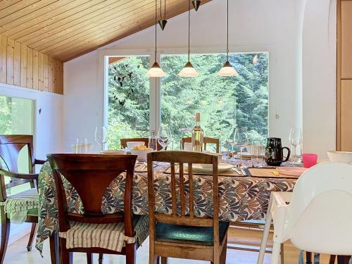 a dining room with a table and a large window at Chalet Chalet Chaudoudoux - Les Paccots by Interhome in Les Paccots