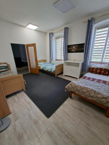a room with two beds and a flat screen tv at Byt v okresu Děčin in Dolní Habartice