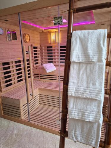 a room with a sauna with a bed and towels at B&B Villa D'Hondt in Blankenberge