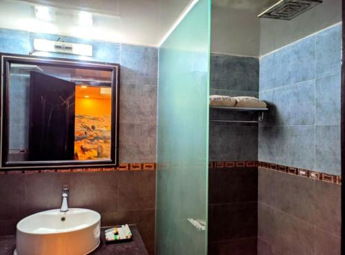 a bathroom with a sink and a mirror at Hotel Inani Long Bay in Cox's Bazar