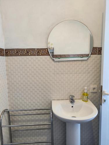 a bathroom with a sink and a mirror at MD Amed Guest House in Amed