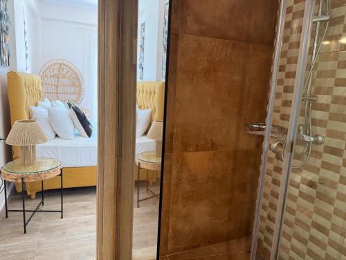 a bathroom with a shower and a bedroom with a bed at Dolphin House by the sea in Porto Ozias
