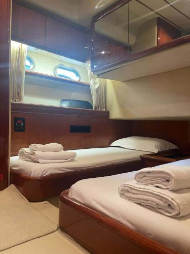 a bedroom with two beds on a boat at The Duke Superyacht - LINDIAN in Lindos