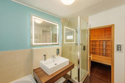 a bathroom with a sink and a shower and a toilet at Center Parcs Bostalsee Saarland in Nohfelden