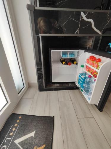 a small refrigerator with its door open in a room at Magic House in Palermo