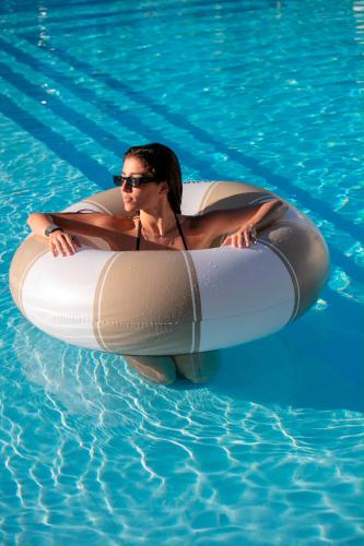 a man is in an inner tube in a swimming pool at Residence Stellaris Apartrooms in Termoli