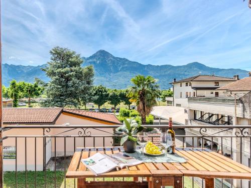 a table on a balcony with a view of mountains at Apartment Legnone by Interhome in Sorico