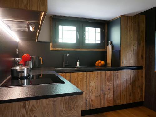 a kitchen with a sink and a counter top at Apartment Apt- Terrace by Interhome in Olivone