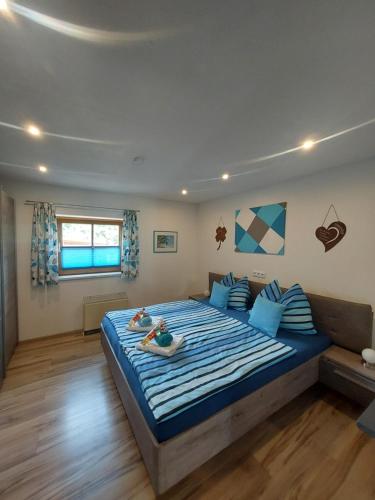 a bedroom with a large bed with two dolls on it at Ferienwohnung Kasbacher in Bruck an der Großglocknerstraße