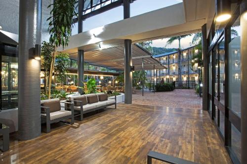 an empty lobby of a building with couches and tables at Mantra Club Croc in Airlie Beach
