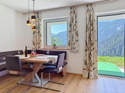 a dining room with a table and two windows at Apartment Eben by Interhome in Hippach