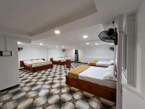 a bedroom with two beds and a living room at nkm cottage in Rāmeswaram