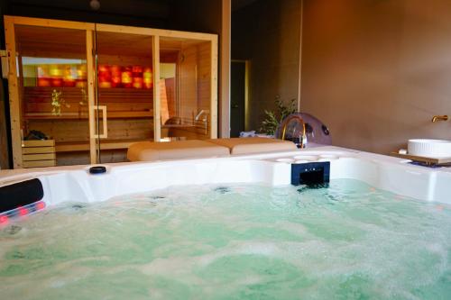 a bath tub with a sink in a bathroom at Casa d'Amares in Amares