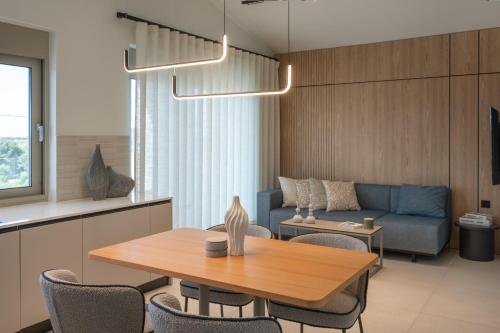 a living room with a table and a couch at Kleopatra Homes - Napoleontos in Messini
