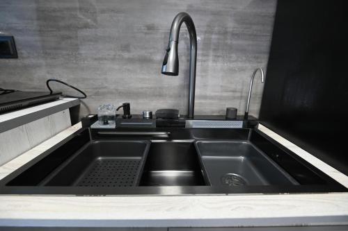 a kitchen with a stainless steel sink and a faucet at Jivani 105 in Gyumri