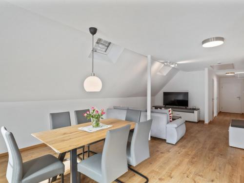 a dining room and living room with a table and chairs at Apartment Laura - S7 by Interhome in Endingen