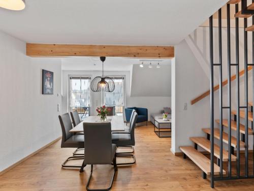 a dining room and living room with a table and chairs at Apartment Nina - 9 by Interhome in Endingen