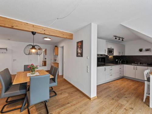 an open kitchen and dining room with a table and chairs at Apartment Nina - 9 by Interhome in Endingen