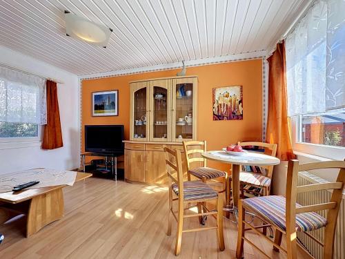 a living room with a table and chairs and a television at Apartment Gabi-1 by Interhome in Wiek auf Rügen