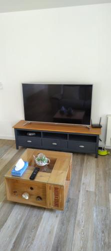 a flat screen tv sitting on top of a coffee table at Gîte du Tilleul in Beire-le-Châtel