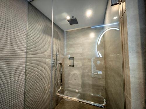 a shower in a bathroom with a glass door at Hotel Windy Terrace in Cox's Bazar