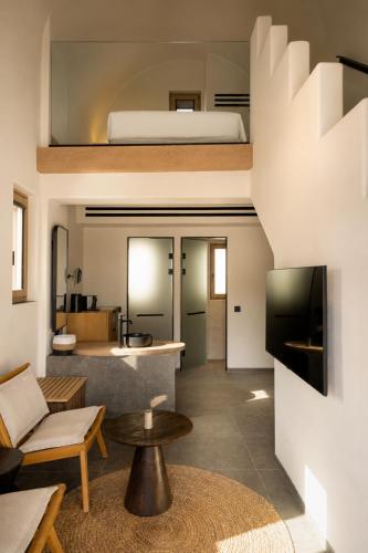 a living room with a couch and a bed at Radisson Blu Zaffron Resort, Santorini in Kamari
