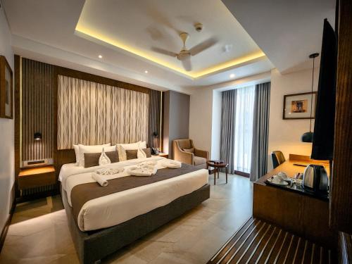 a hotel room with a large bed and a desk at Hotel Windy Terrace in Cox's Bazar