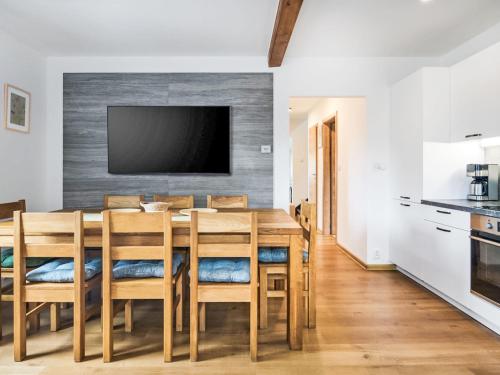a kitchen and dining room with a wooden table and chairs at Chalet Golden View by Interhome in Janske Lazne