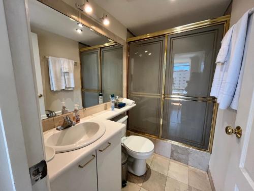 a bathroom with a sink and a toilet and a shower at BlueZone Apartments in Quito