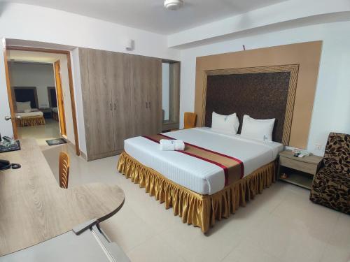 a bedroom with a large bed in a room at Cox West Inn in Cox's Bazar
