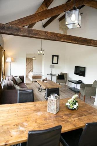 a living room with a wooden table and a couch at Tip !!! Appartementen Leonardus in Valkenburg