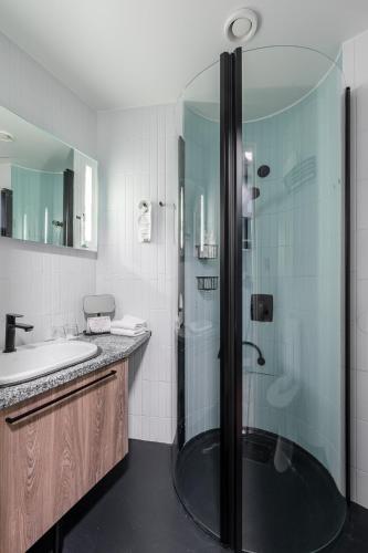 a bathroom with a shower and a sink at Ikaalinen SPA & Resort in Ikaalinen